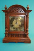 A late 19th century walnut bracket clock with brass chapter ring and dial, the glazed doors flanked