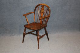 A 20th century Windsor wheelback chair, stamped J F.