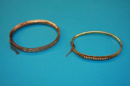 A 15ct gold and seed pearl bangle and a 9ct gold bangle. Total weight 14.2 grams