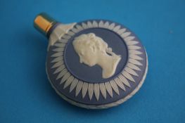 A circular Wedgwood blue jasperware scent bottle each side decorated with a classical  bust, with