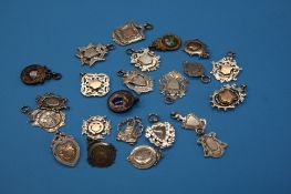 A collection of twenty three silver watch fobs, some enamelled.Total weight 6.6 oz