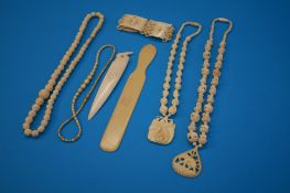 Four ivory necklaces; a bracelet and two letter openers, circa 1920`s. (7)