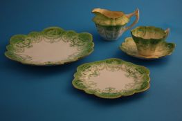 A Charles Wileman Foley china tea service of lobed shape, printed in green with panels of classical
