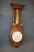 A large carved oak 2 glass barometer by J Thompson and Co, 65 Lord St, Liverpool.106 cm high