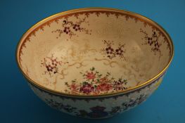 A 19th century armorial circular bowl decorated with panels of flowers in enamels and with gilt