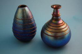 Two Alchemy glass vases each of a metallic purple and blue lustre decorated with a trail of glass