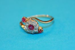 An 18ct gold diamond and 3 stone ruby ring.