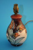 A modern Moorcroft table lamp decorated with tulips, impressed mark. 26 cm high