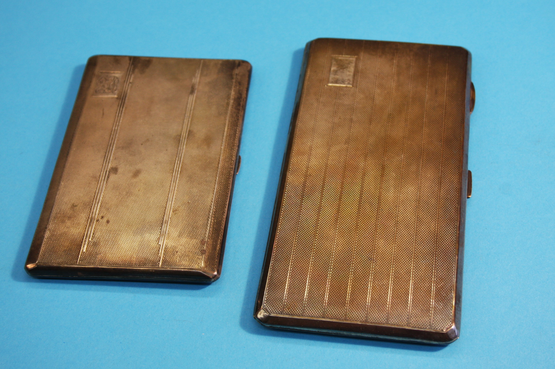 Two engine turned silver cigarette cases. Weight 16 oz