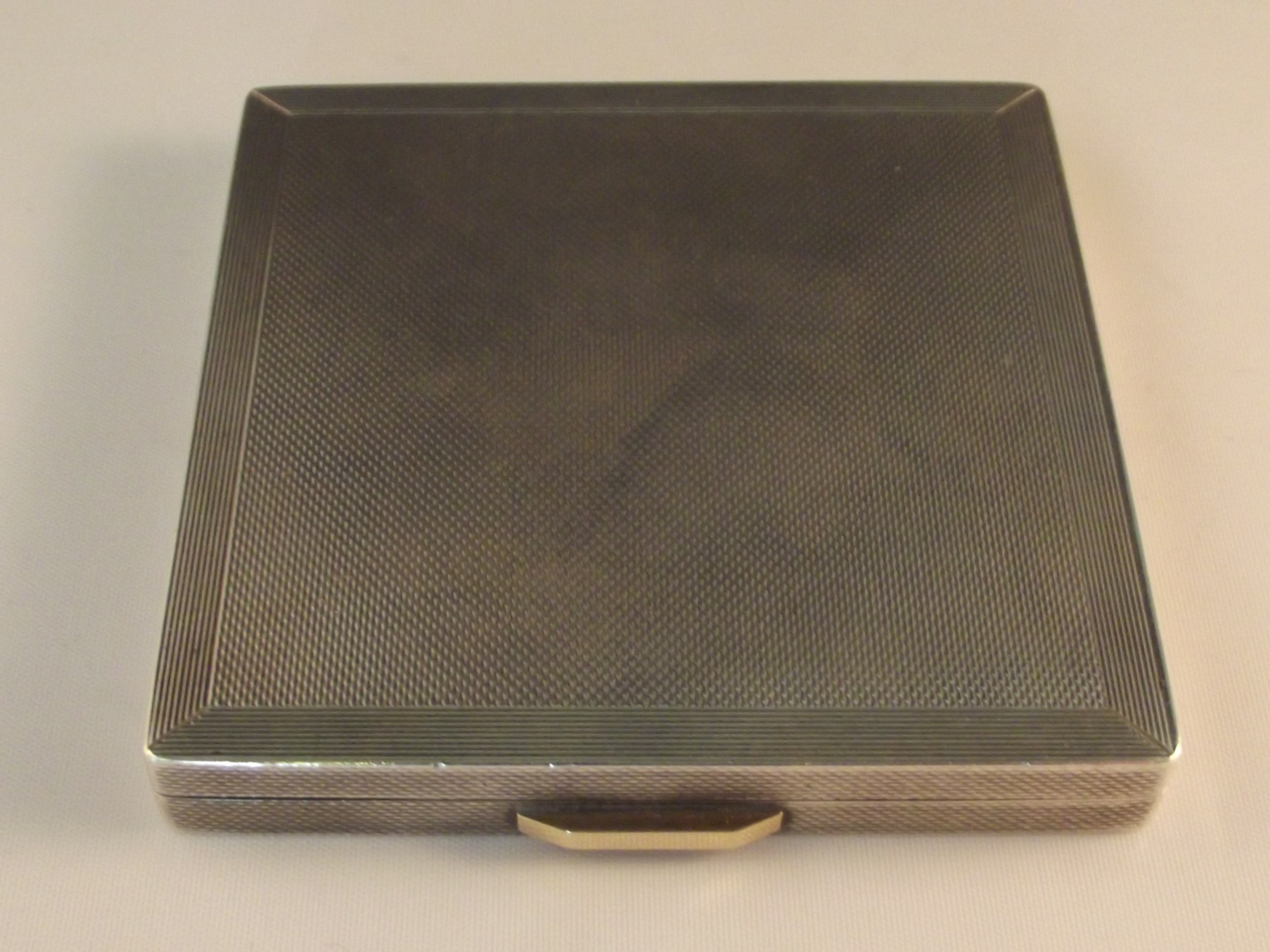 Silver powder compact of square form with engine turned decoration, London, 1948, 17cm x 17cm, 113