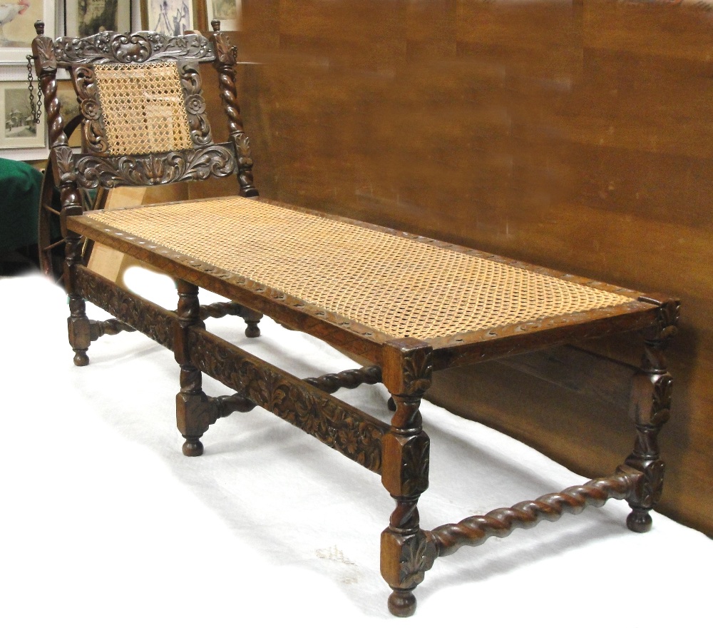 A Day Bed:
Victorian, Oak, the back splat with floral scroll decoration, the rattan centre flanked