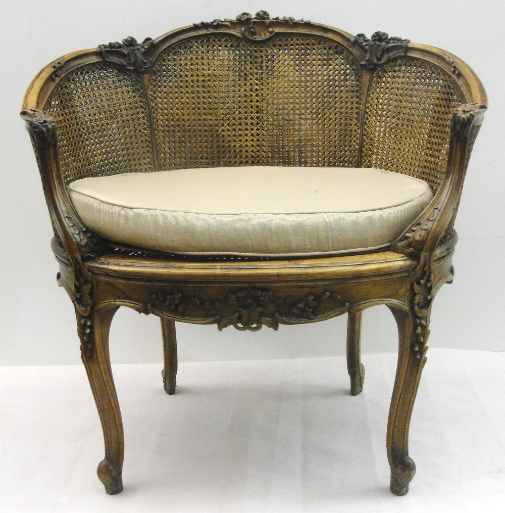 A Late 19th Century French Bergere Tub Chair:
of small proportions, the frame carved with acanthus