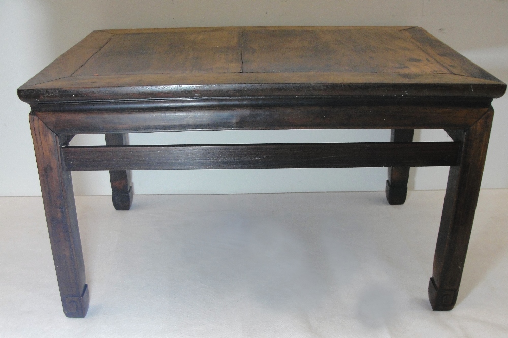 A Chinese Hardwood Table:
18th century 
on square legs joined by stretchers, H 45cm x W 76cm x D
