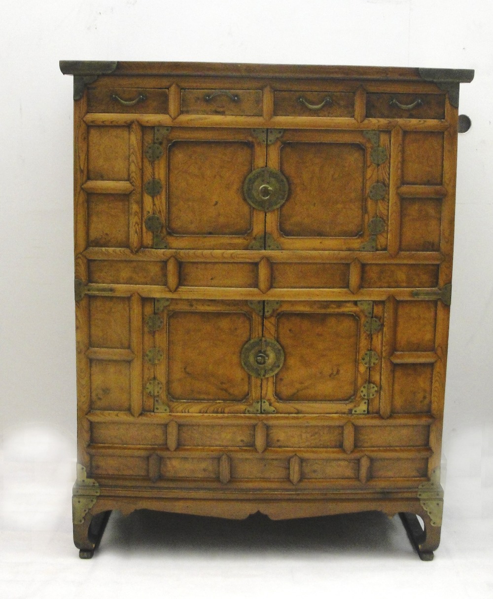 A Large Chinese Yew Wood And Brass Mounted cabinet: 
the overhanging rectangular top above an