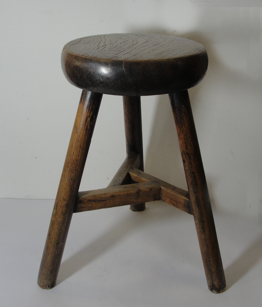An Elm Stool:
19th century, Chinese provincial style, with swept tripod support and circular