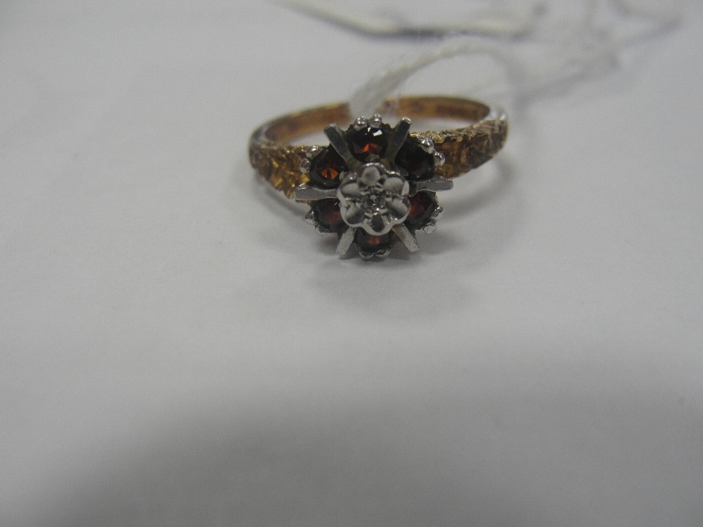 A 9ct garnet and diamond dress ring