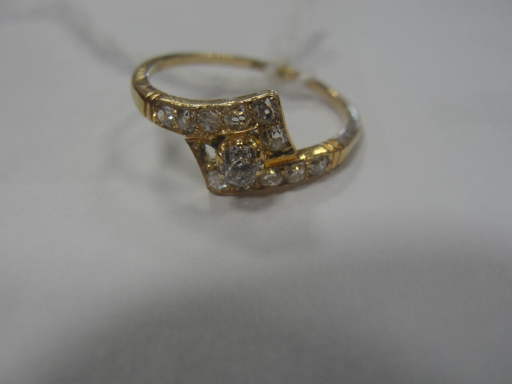 A 1930s diamond dress ring, Georgian cut diamonds set to shoulder in crossover pattern with raised