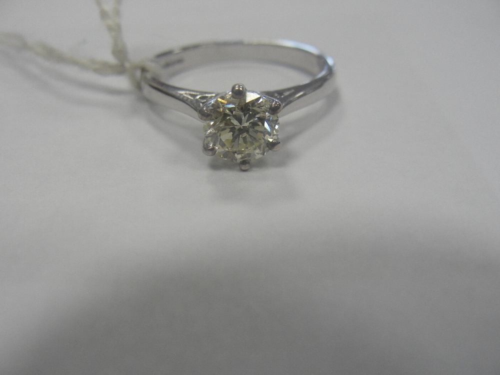 An 18ct gold .75ct diamond solitaire : champagne colour