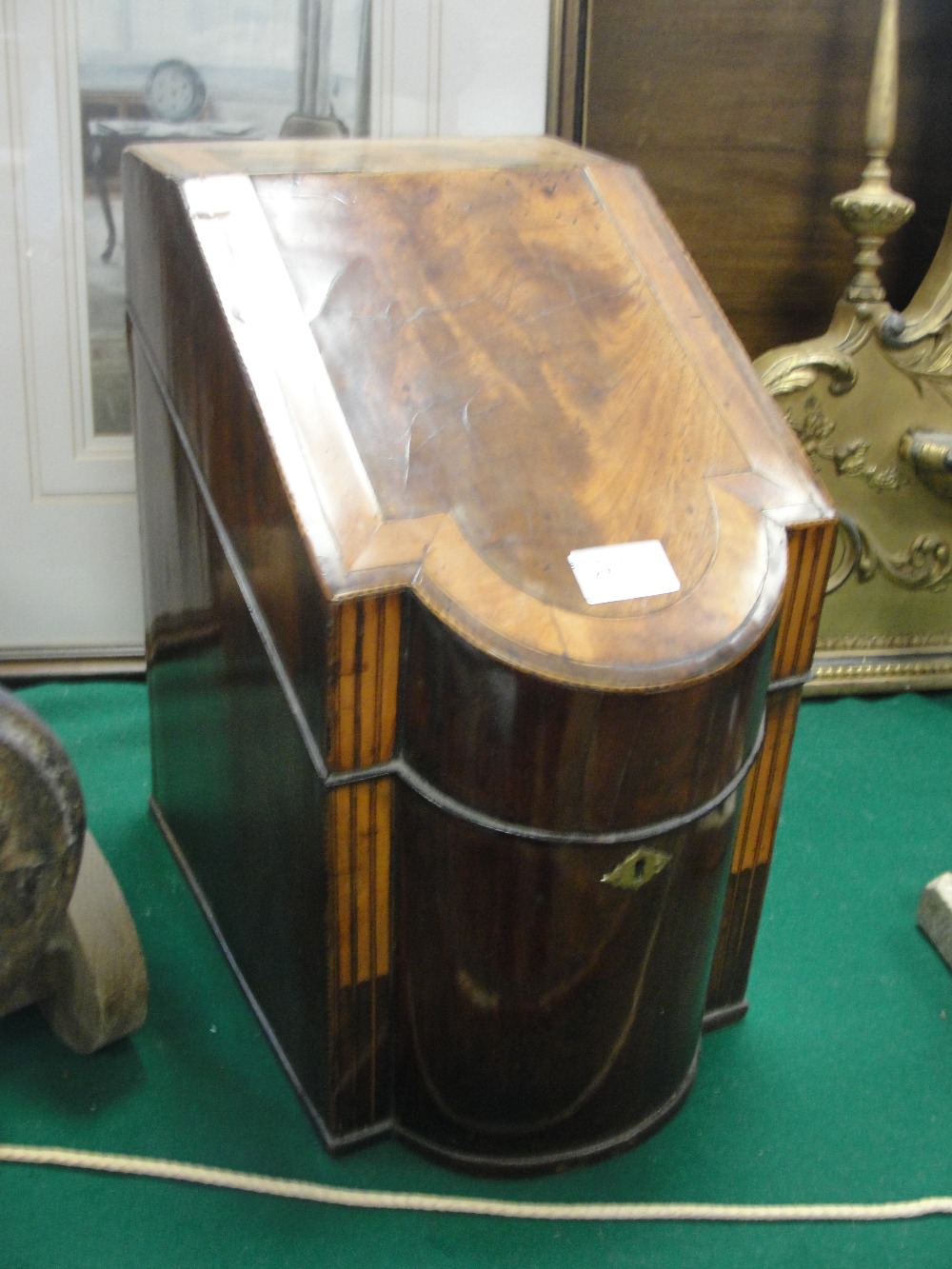 A Georgian mahogany knife box with a fitted interior with serpentine front applied with a brass