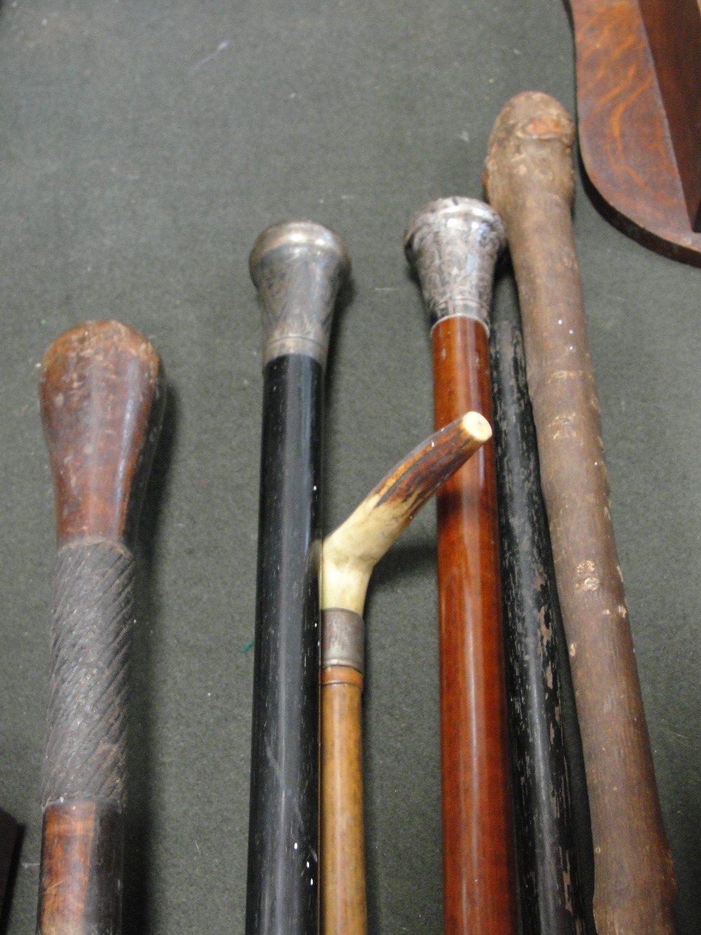 A quantity of walking sticks to inc two silver-topped examples
