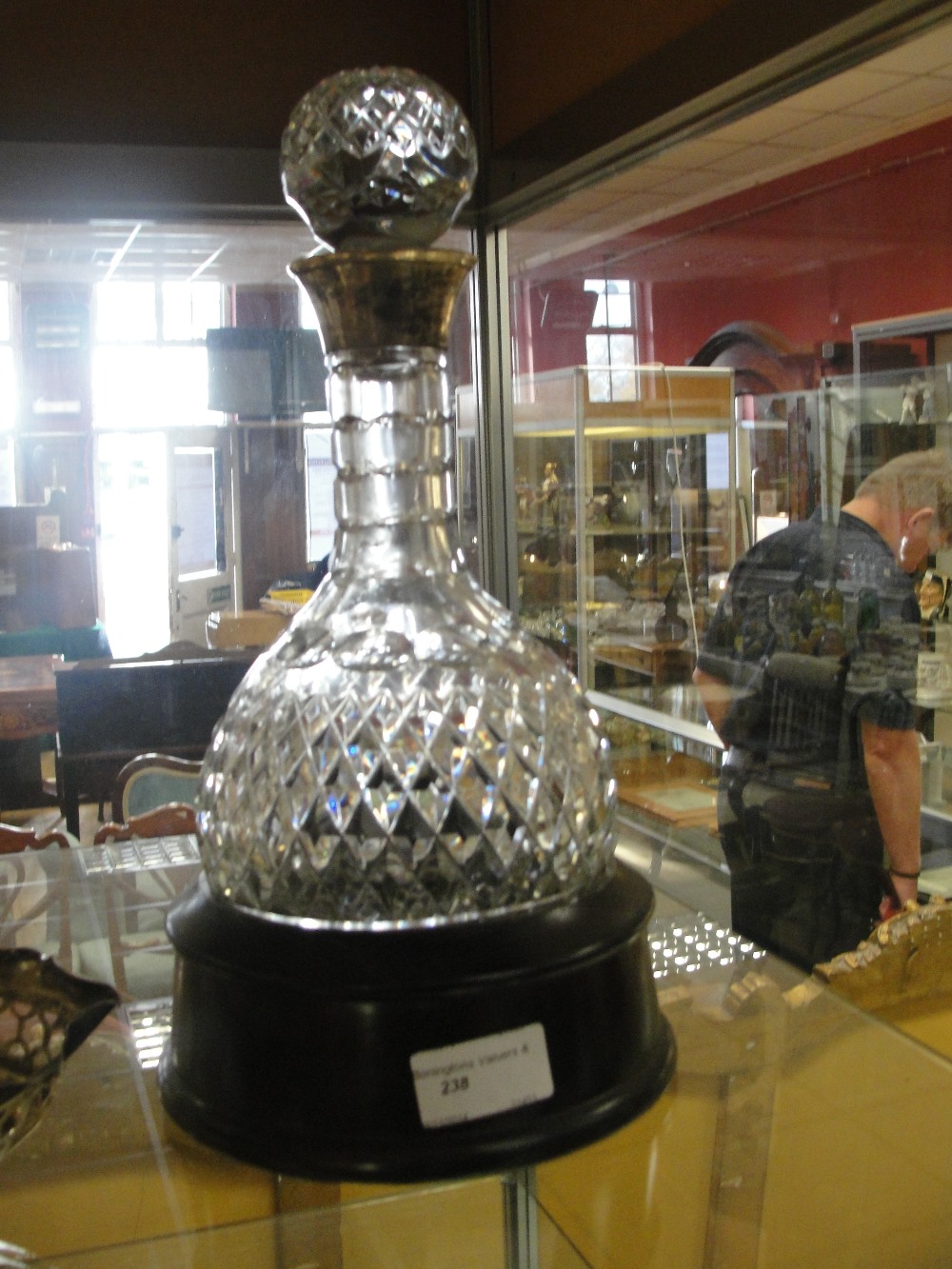 A HM silver-rimmed decanter in stand