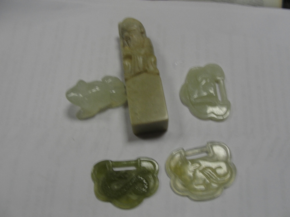 Four small pieces of jade; together with a carved figure