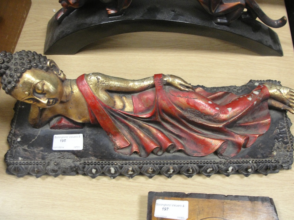 An Oriental figure of a reclining lady