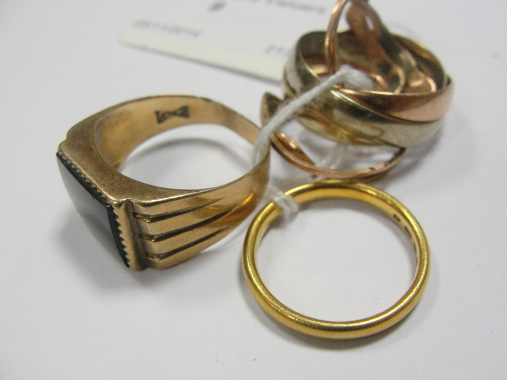 Three 9ct gold rings; together with a 22ct gold ring