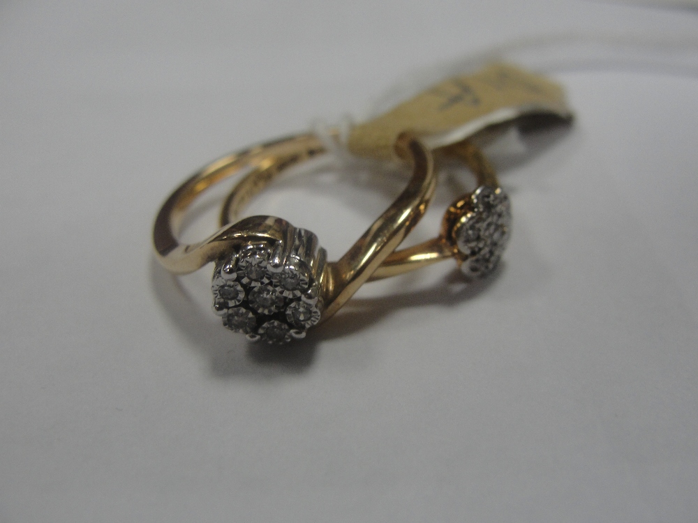 An 18ct diamond daisy ring; together with a 9ct diamond example