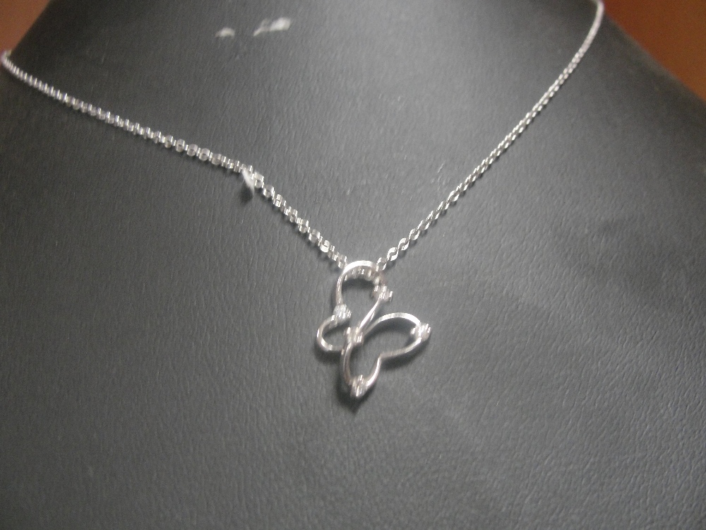 An 18ct chain and diamond set pendant