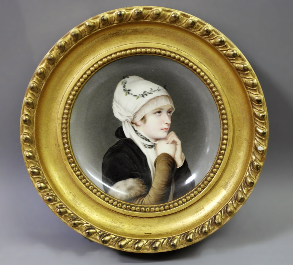 A Berlin-Style Plaque:
a framed Berlin-style plaque of a pretty young lady wearing a headscarf.