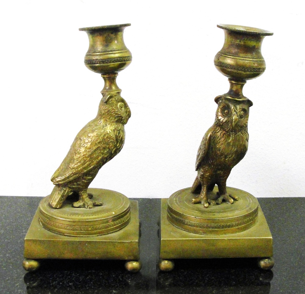 A Pair of 19th Century Brass Owl Candlesticks:
single sconce sticks on owl figure on dais on a