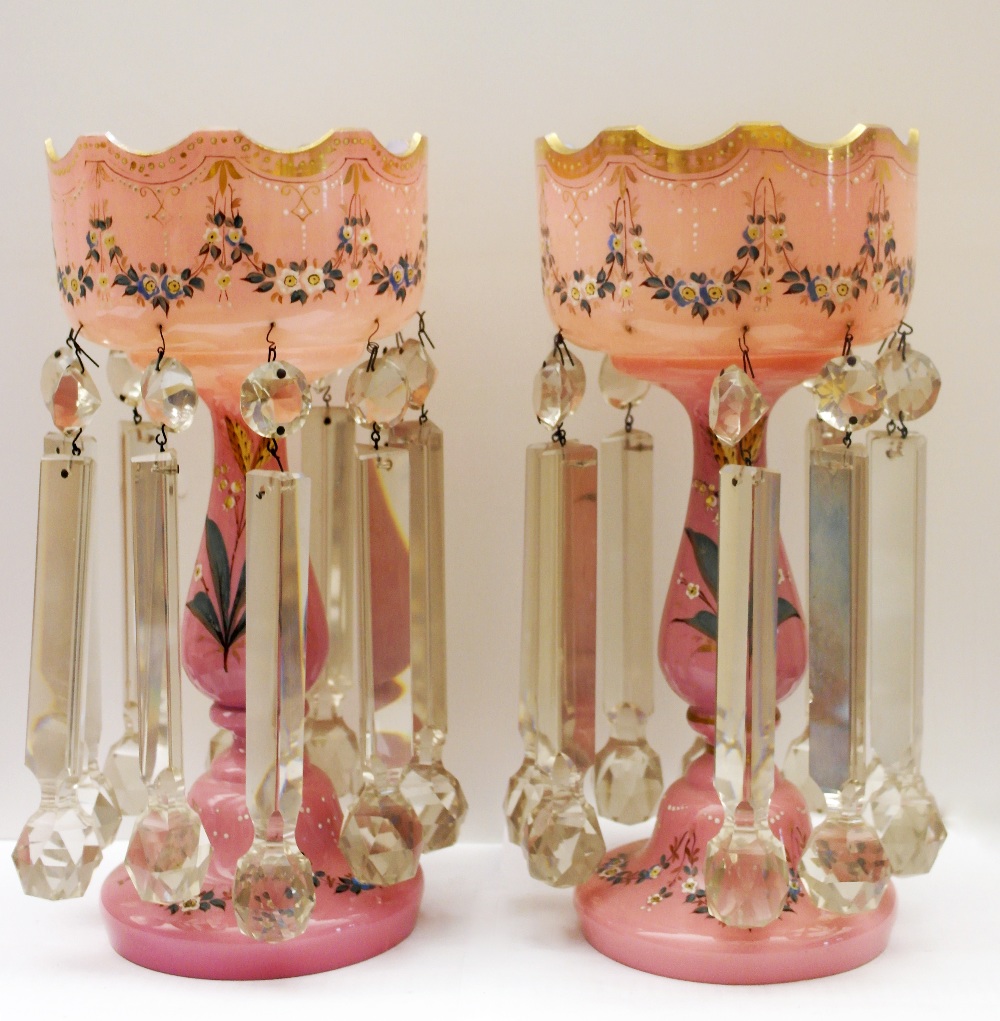 A Pair of 19th Century Lustres:
the clear glass droplets hanging from pink glass stands decorated