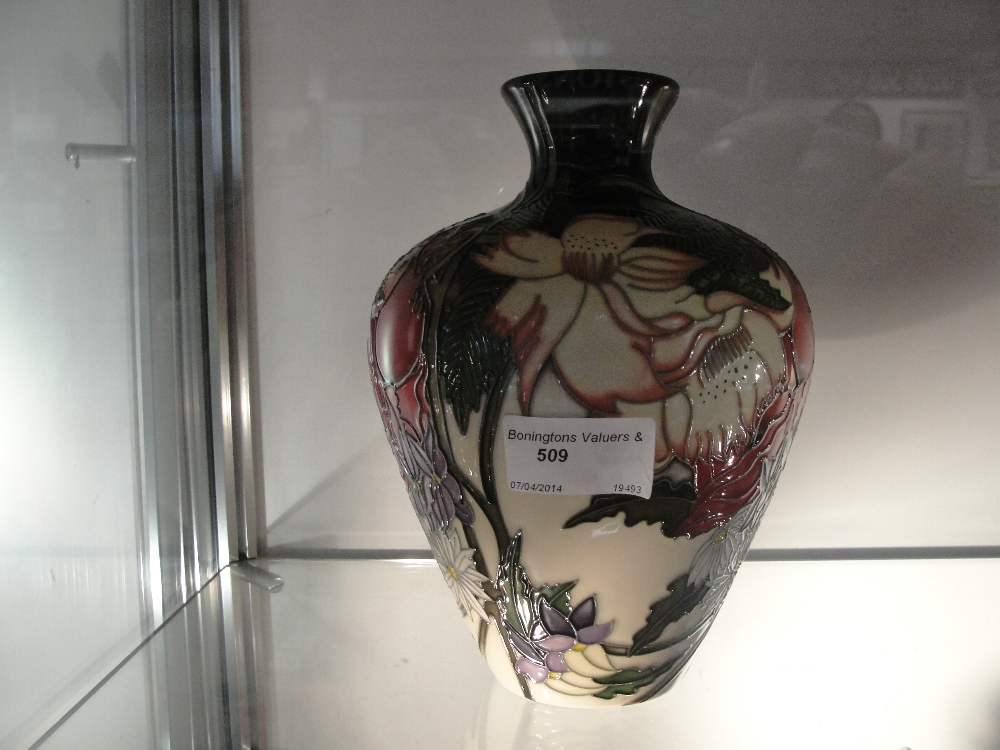 A Moorcroft tubelined vase with orchid pattern