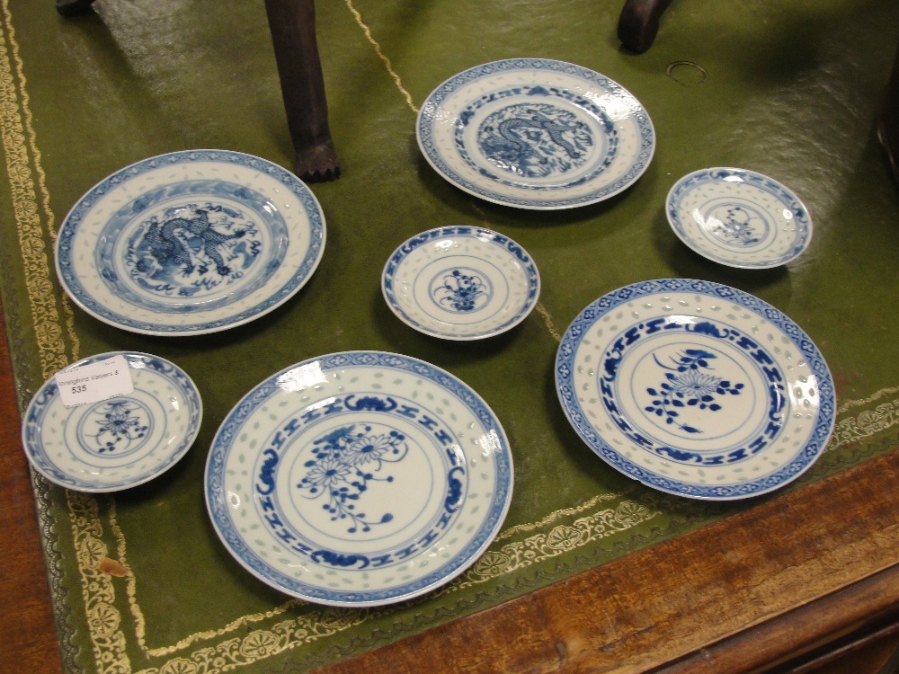 A quantity of blue and white Chinese saucers and bowls with dragon and floral design