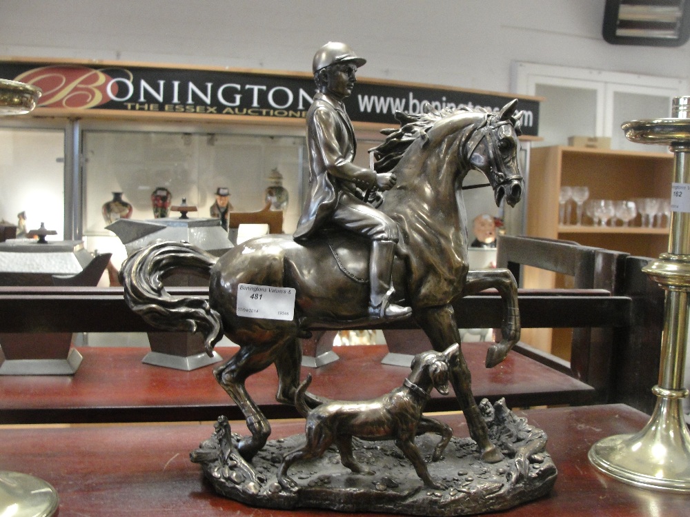 A resin figure of a horse, a hunter and his dog