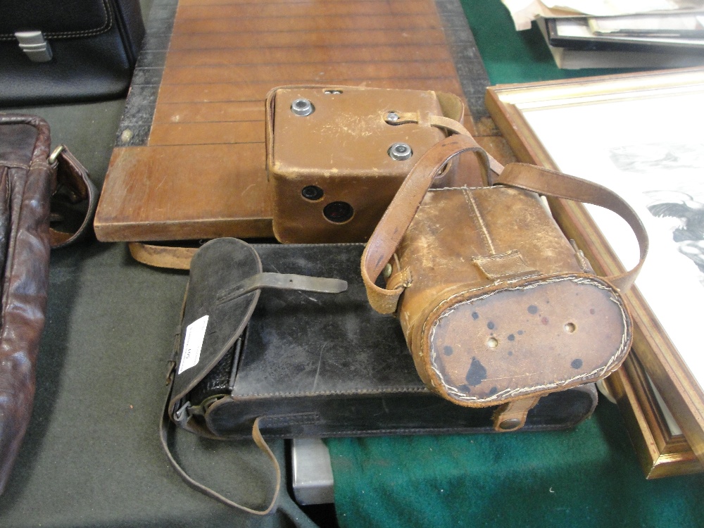 A large Kodak Bellows camera; together with a Box Brownie and a pair of cased binoculars