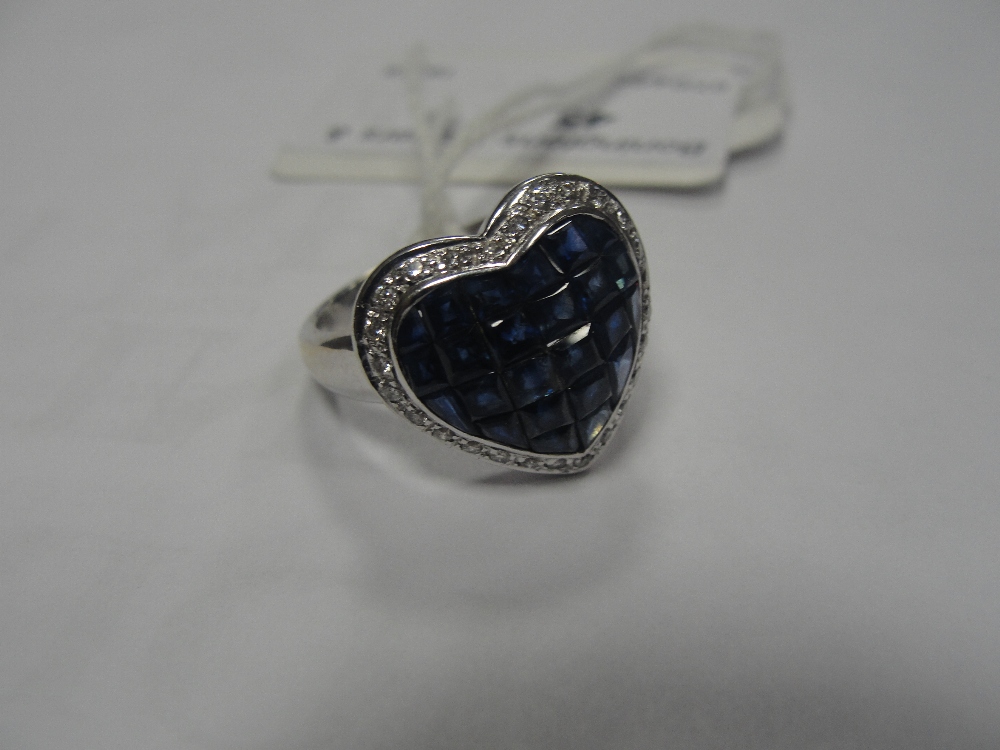 A diamond and sapphire heart ring