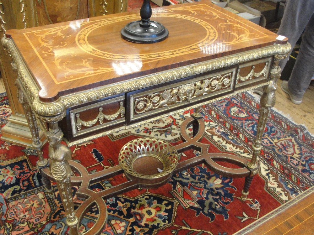 A marquetry kinwood Louis XVI-style table with gilded mounts