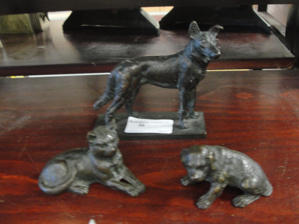 Two early 20th century bronze dogs; together with a bronze cat