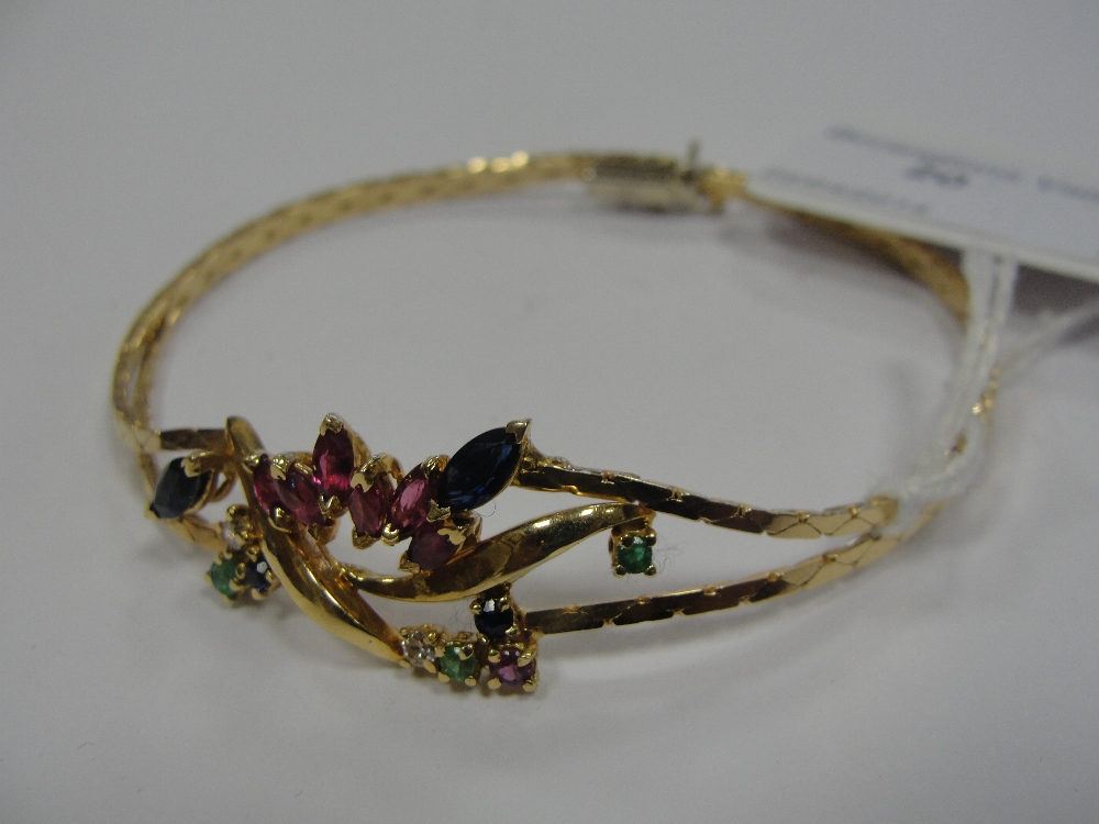 An 18ct bracelet set with marquise and brilliant cut diamonds, sapphires, emeralds and rubies