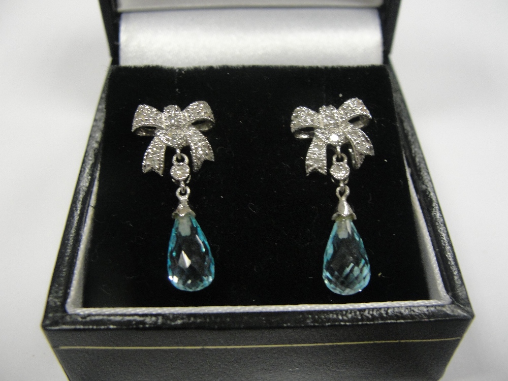 A pair of 9ct diamond set bows with suspended briolette topaz