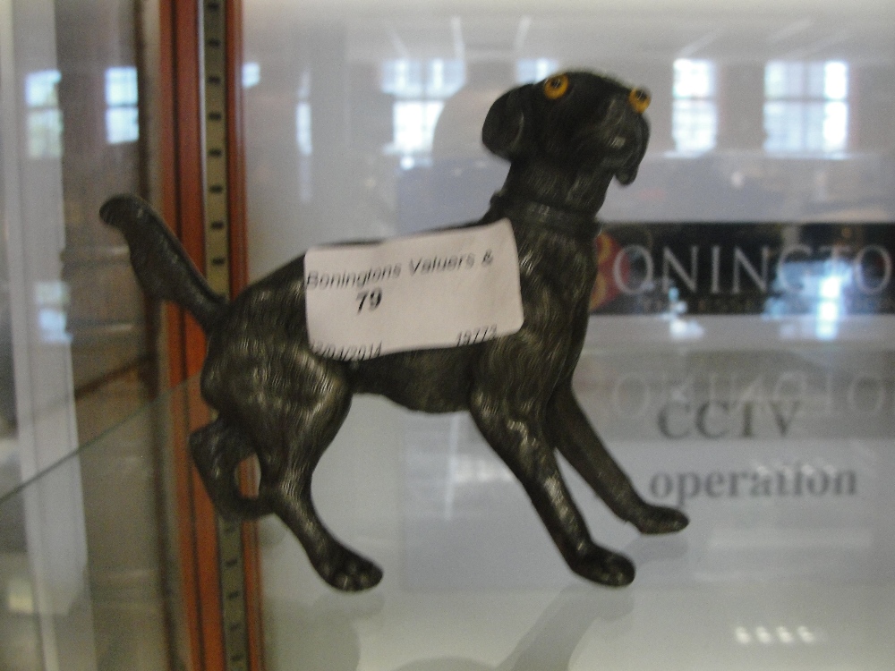 A pewter pepper in the form of a dog