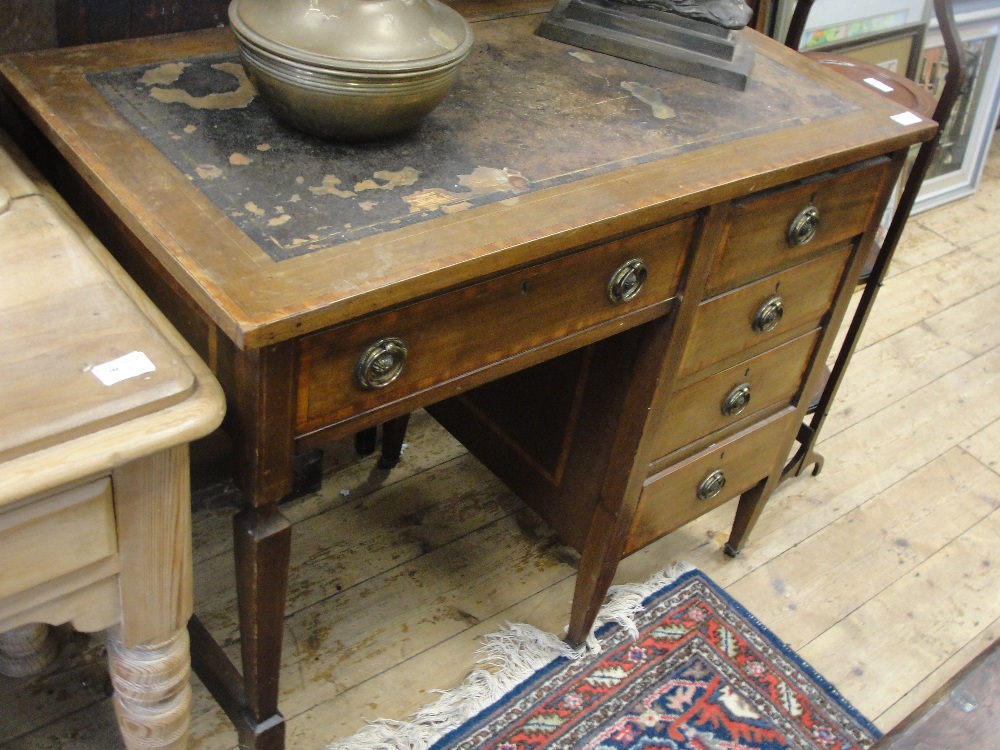 An Edwardian mahogany single pedestal desk