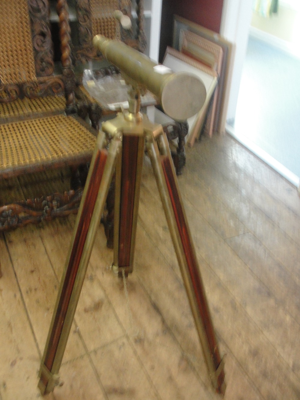 A modern brass vintage-style telescope on tripod