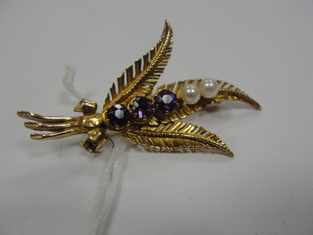 An amethyst and pearl brooch