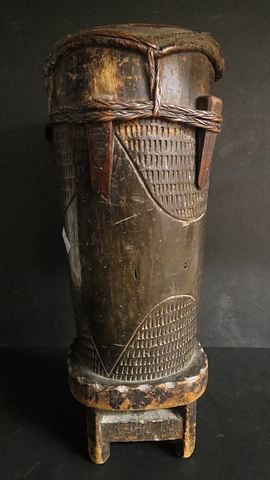 An early 20th century African carved wooden and hide drum with cane ties