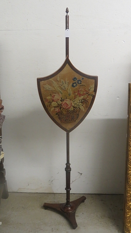 Regency mahogany fire screen with adjustable shield shaped panel, embroidered with floral design