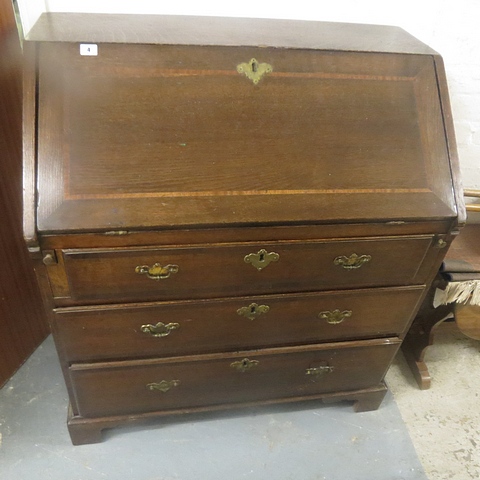 A Georgian oak bureau, the fall flap with inlaid decoration revealing a fitted interior over on