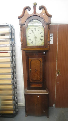 A Georgian mixed wood cased longcase clock, the painted and white enamelled arched dial with Roman